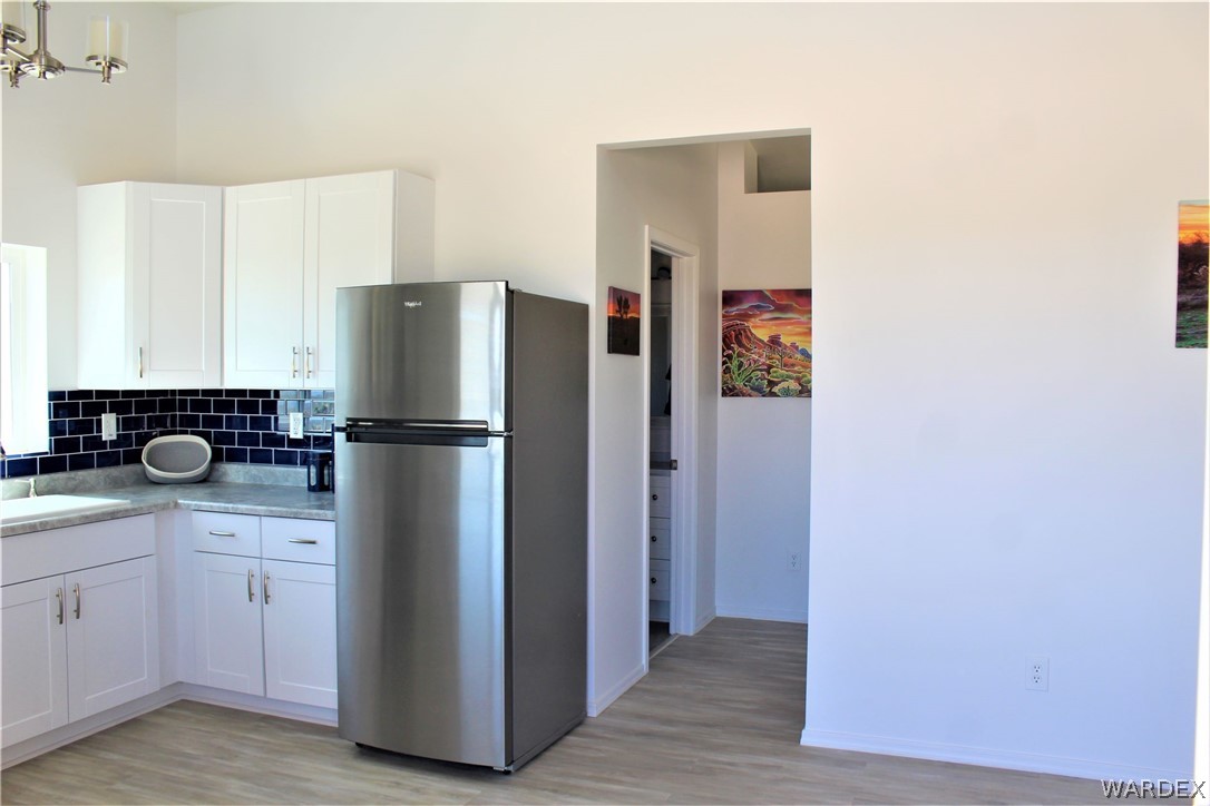 11722 Suzette Road Yucca, AZ 86438 - Photo 9 of 29 a kitchen with a refrigerator and a stove