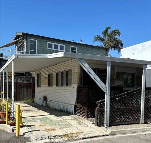 a front view of a house with a potted plant