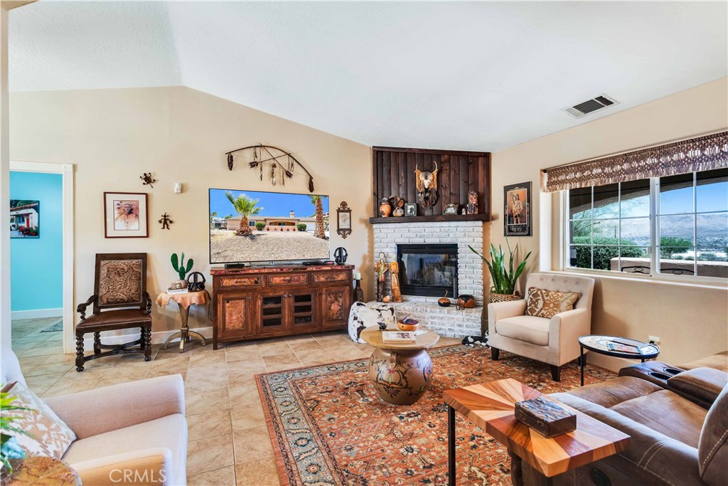 57490 Redondo Street Yucca Valley, CA 92284 - Photo 11 of 60 a living room with furniture fireplace and a large window