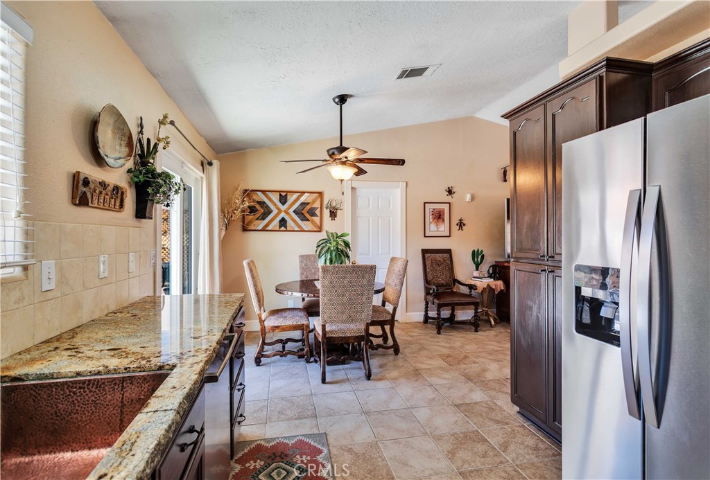 57490 Redondo Street Yucca Valley, CA 92284 - Photo 17 of 60 a living room with furniture and a chandelier