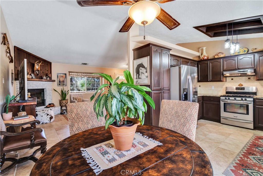 57490 Redondo Street Yucca Valley, CA 92284 - Photo 18 of 60 a living room with furniture a flat screen tv and kitchen view