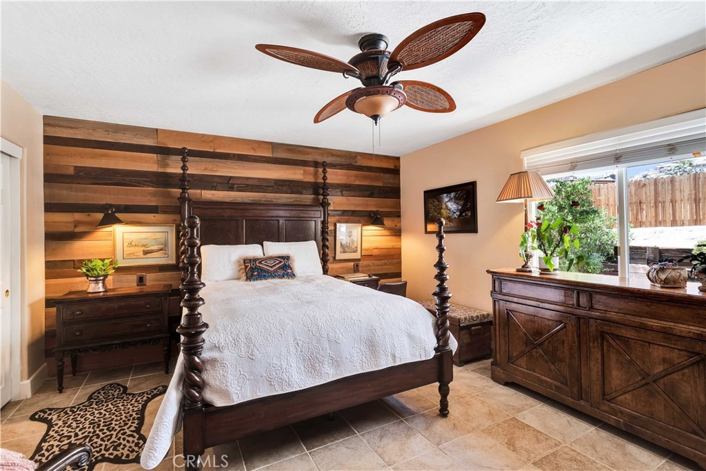 57490 Redondo Street Yucca Valley, CA 92284 - Photo 19 of 60 a bedroom with a bed and a large window