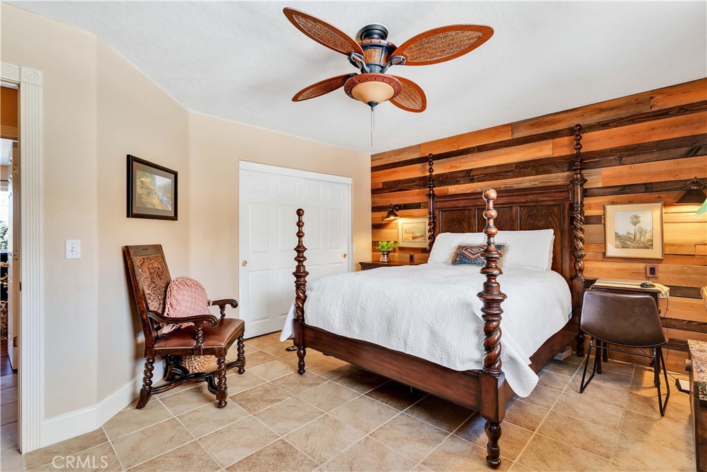 57490 Redondo Street Yucca Valley, CA 92284 - Photo 21 of 60 a bedroom with a bed and a table