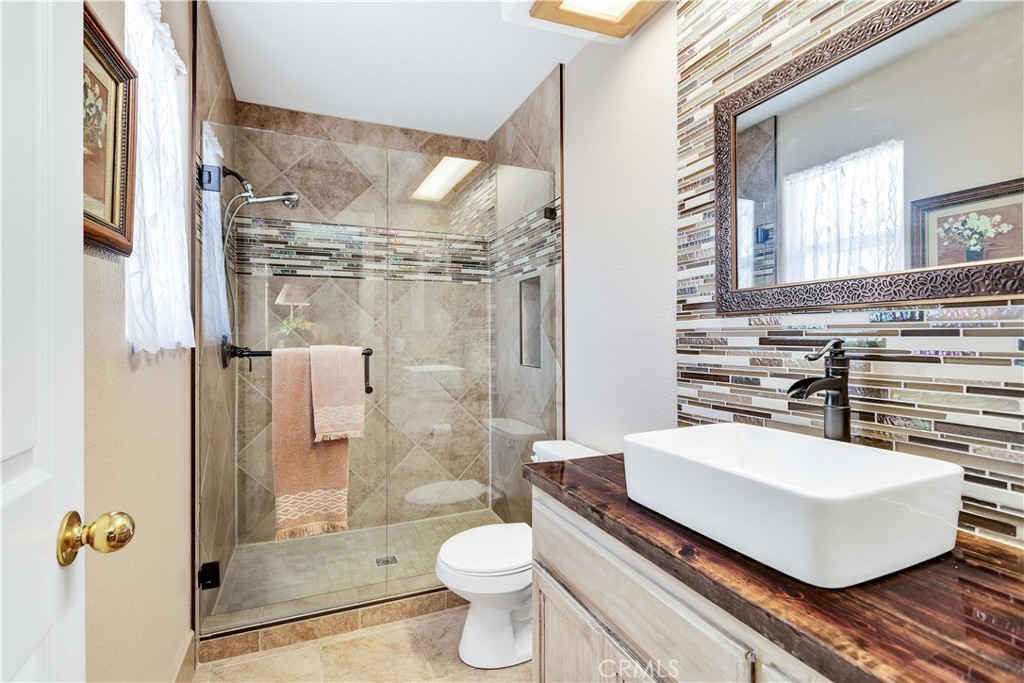 57490 Redondo Street Yucca Valley, CA 92284 - Photo 22 of 60 a bathroom with a sink toilet and shower