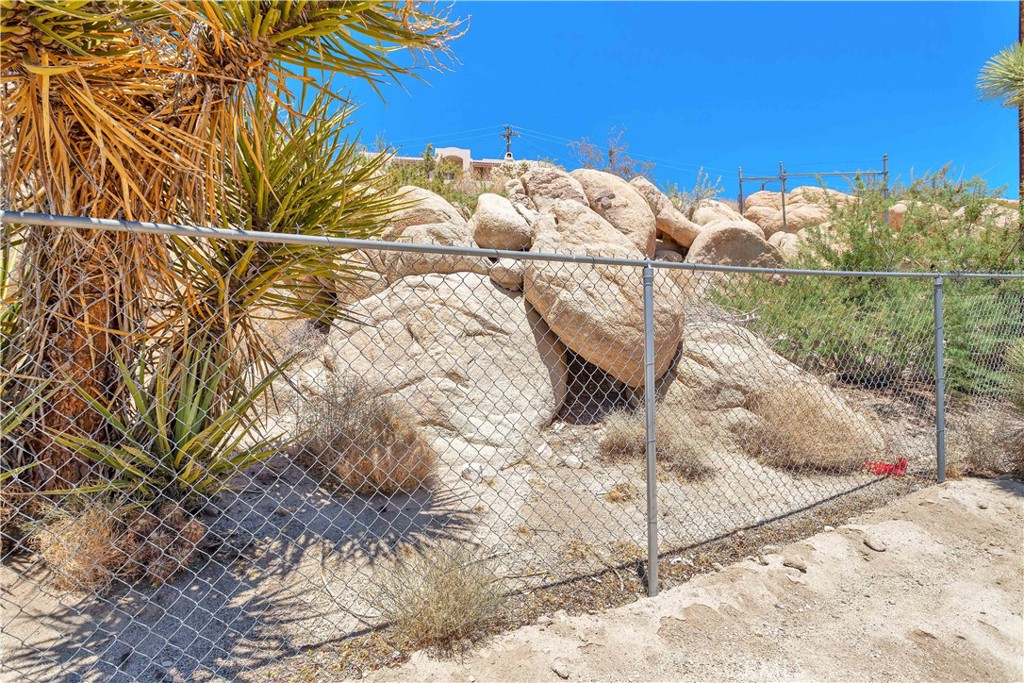 57490 Redondo Street Yucca Valley, CA 92284 - Photo 36 of 60 a view of a yard with a tree