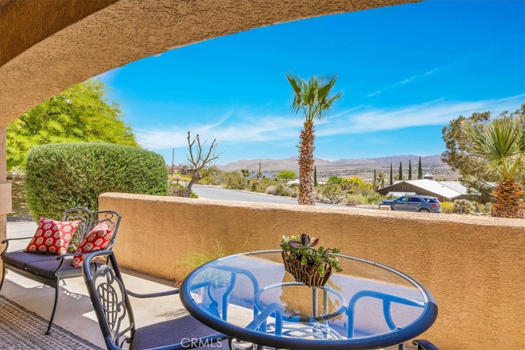 57490 Redondo Street Yucca Valley, CA 92284 - Photo 6 of 60 a view of a chairs and table in the terrace