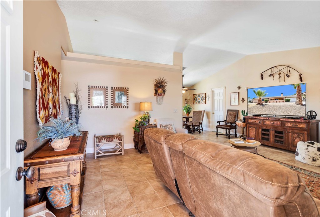 57490 Redondo Street Yucca Valley, CA 92284 - Photo 9 of 60 a living room with furniture and a flat screen tv