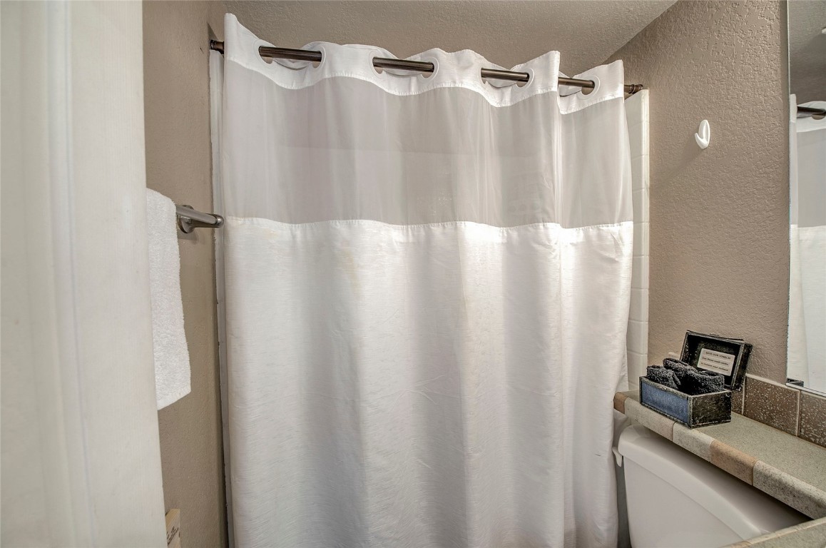 122 Sunshine Loop Fairplay, CO 80440 - Photo 14 of 28 a bathroom with a shower curtain and a sink