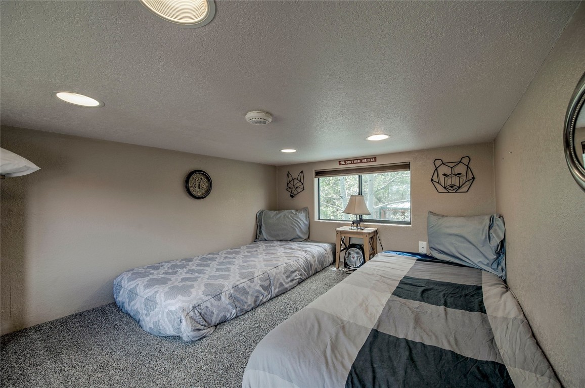 122 Sunshine Loop Fairplay, CO 80440 - Photo 18 of 28 a bedroom with a large bed and a large window