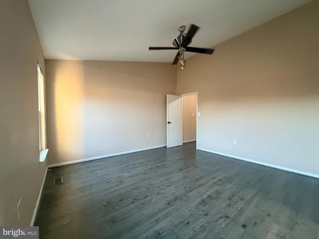 a view of a room with wooden floor and cabinet