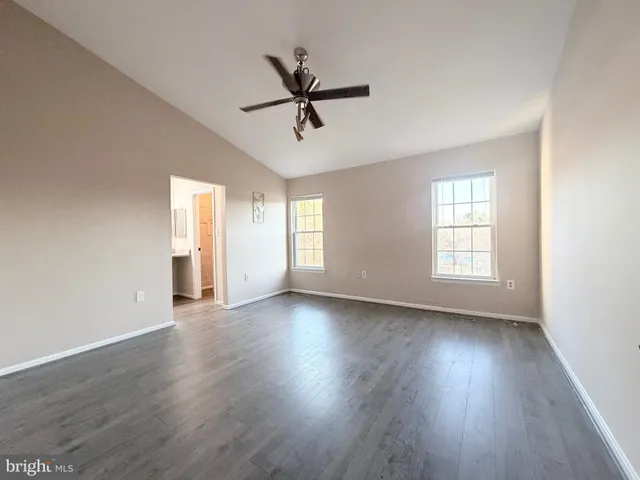 a view of a livingroom with wooden floor and windows