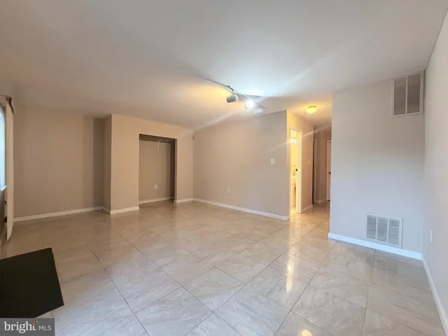 a view of an empty room with a fireplace