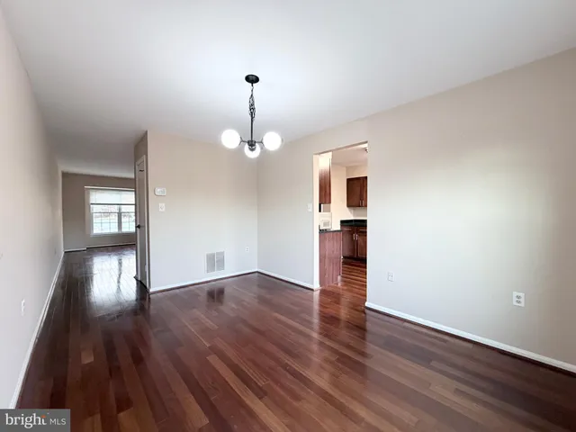 a view of empty room with wooden floor and stove