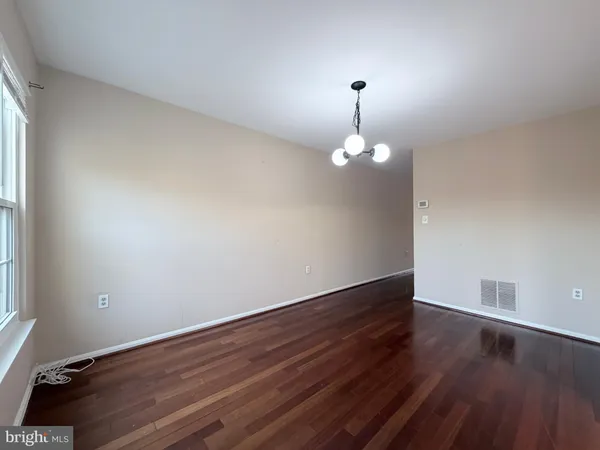 a view of wooden floor and chandelier in a room