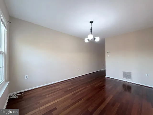 a view of wooden floor and chandelier in a room