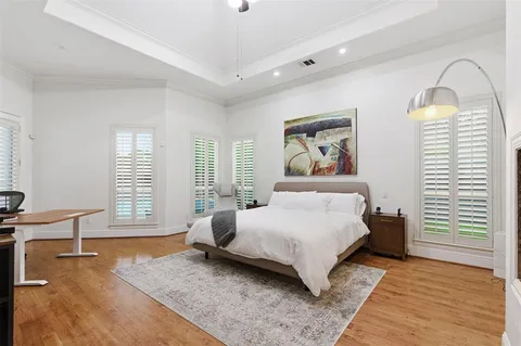 a bedroom with a bed and a large window