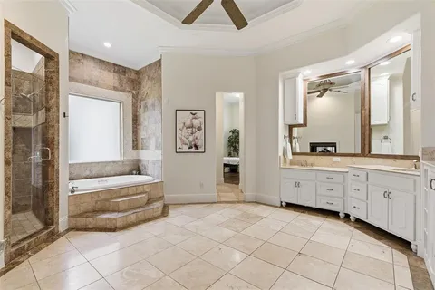 a spacious bathroom with a double vanity sink a mirror and a bathtub