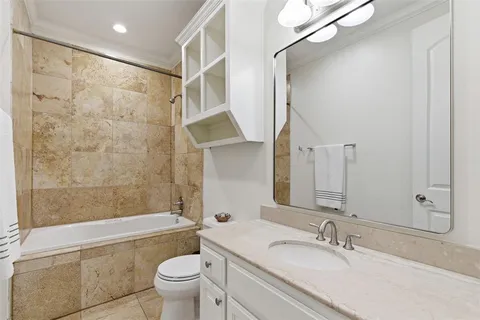 a bathroom with a sink toilet tub and shower