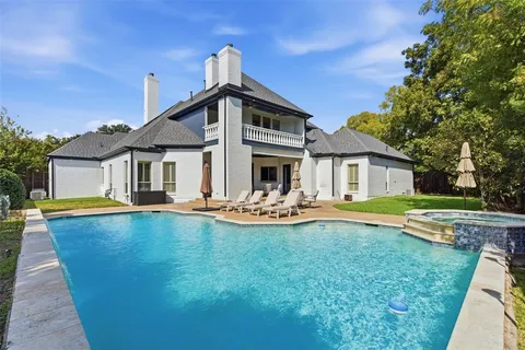 a front view of a house with swimming pool having outdoor seating