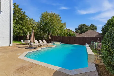 a view of a house with swimming pool and sitting area
