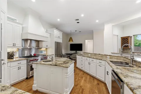 a kitchen with a sink stove and cabinets