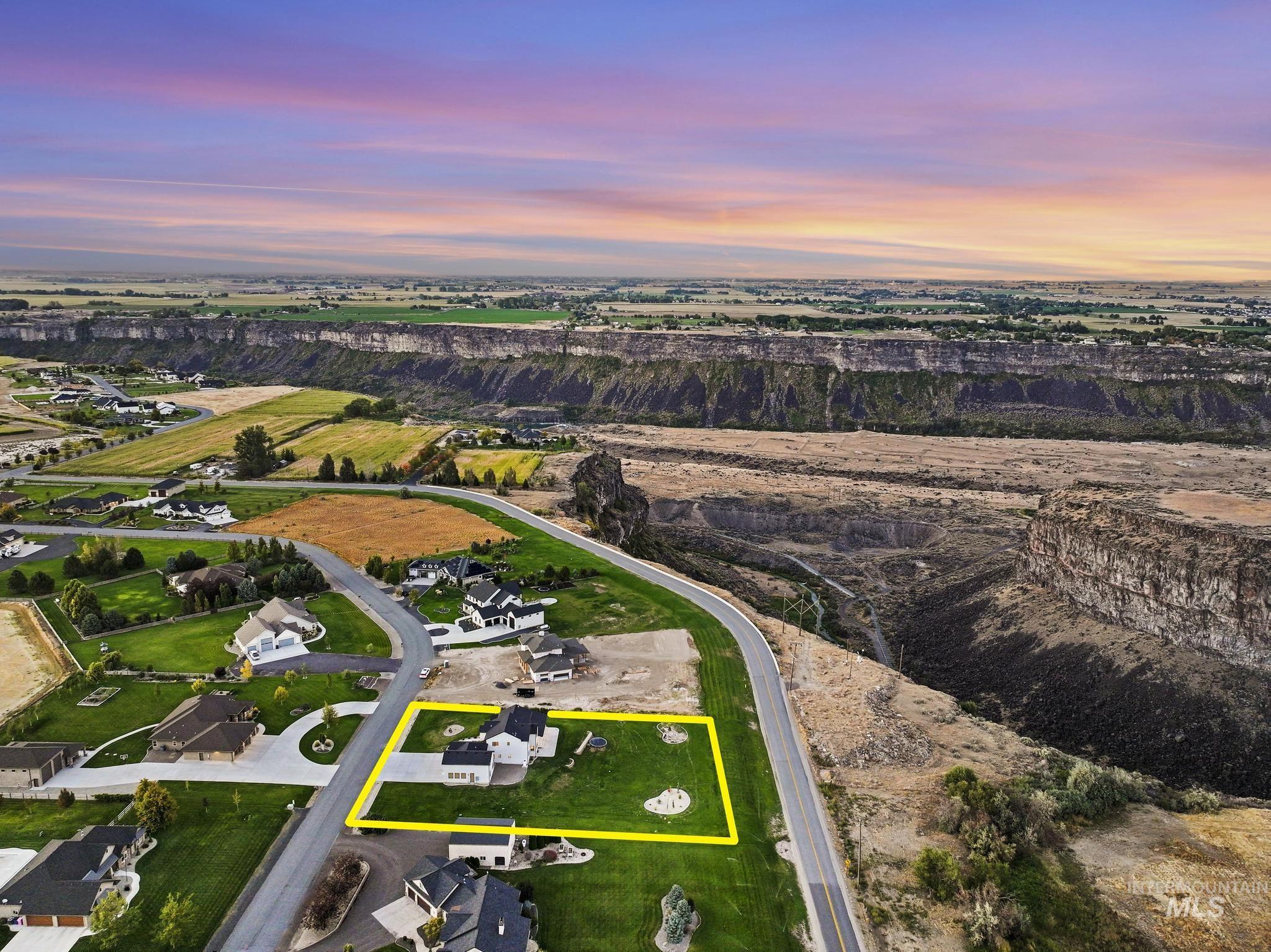 4280 Rim Vista Road Filer, ID 83328 - Photo 49 of 50 Aerial perspective showcasing a property with a manicured lawn, paved driveway, and established landscaping