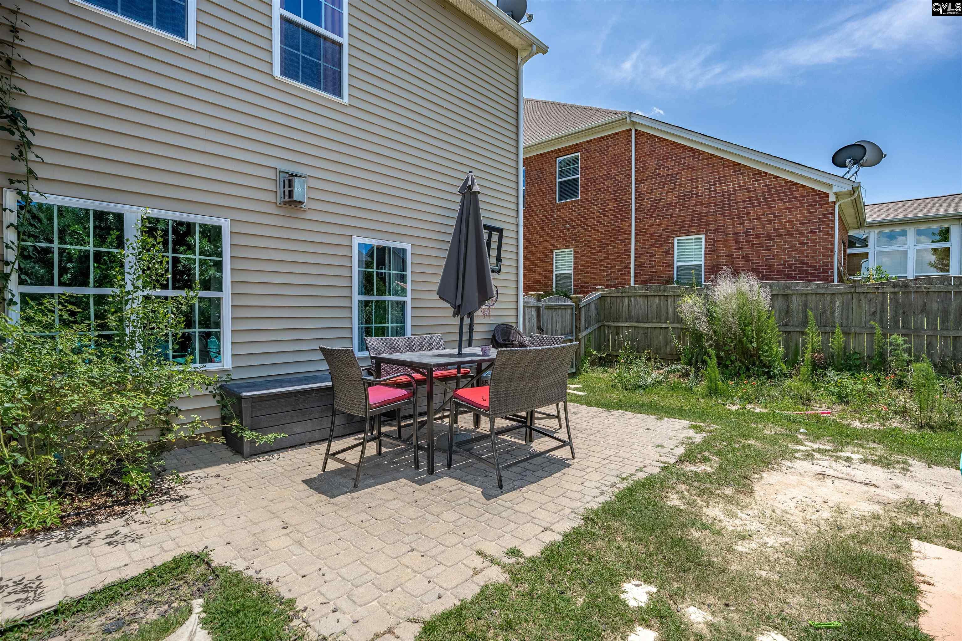 321 Asa Rose Lexington, SC 29072 - Photo 42 of 52 a view of backyard with table and chairs and potted plants