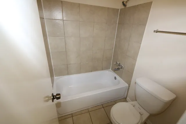 a bathroom with a toilet and a bathtub