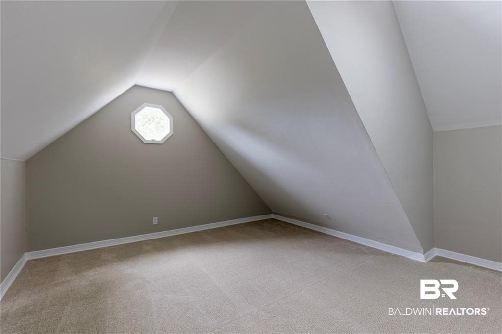 101 Lawson Road Daphne, AL 36526 - Photo 14 of 20 Carpeted room featuring an octagonal window, sloped ceilings, and neutral wall paint
