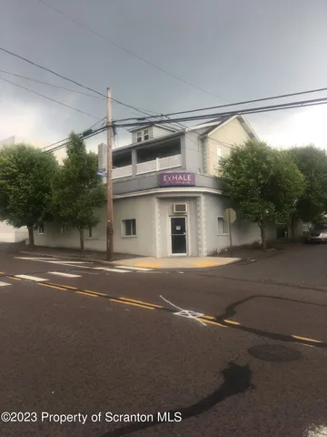a view of a street with a building in the background