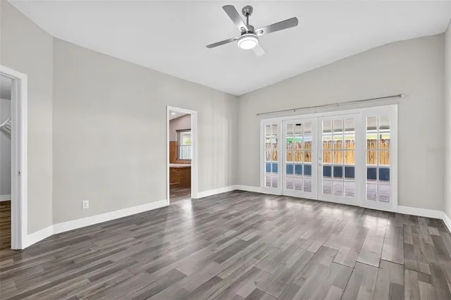 a view of an empty room with wooden floor