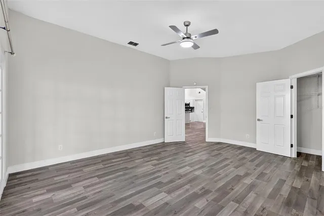 a view of an empty room with wooden floor