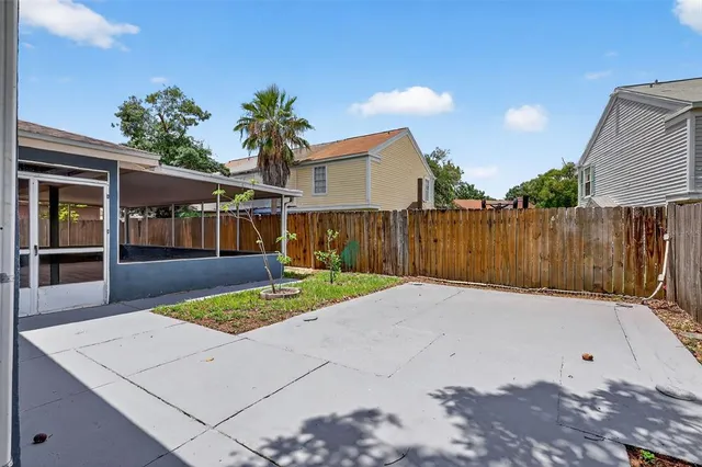 a backyard of a house with table and chairs