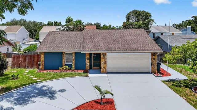 a front view of house with yard and trees