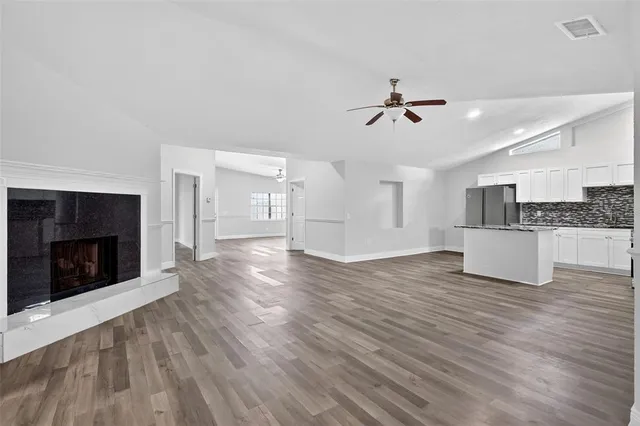 a view of an empty room with wooden floor