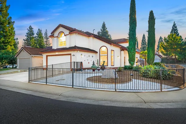 a view of a street with a iron fence