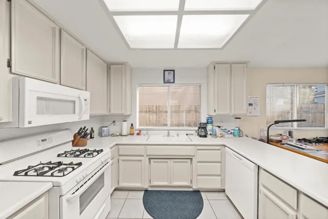 a kitchen with a sink stove and cabinets