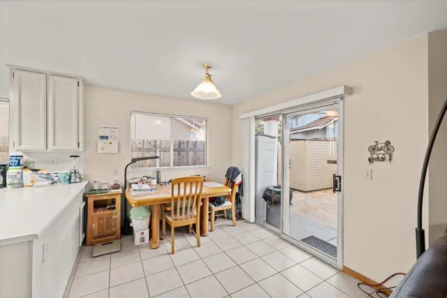 a dining room with furniture and a window