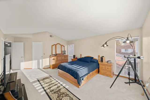 a bedroom with a bed and a dresser