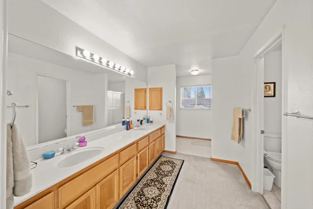 a bathroom with a tub sink and mirror