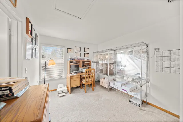 a view of a livingroom with lounge chair and a large window