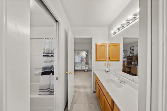 a en suite bathroom with a double vanity sink a mirror and a shower