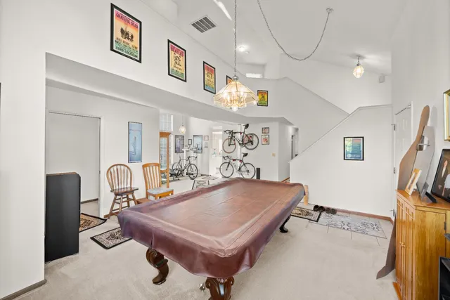 a room with pool table and windows