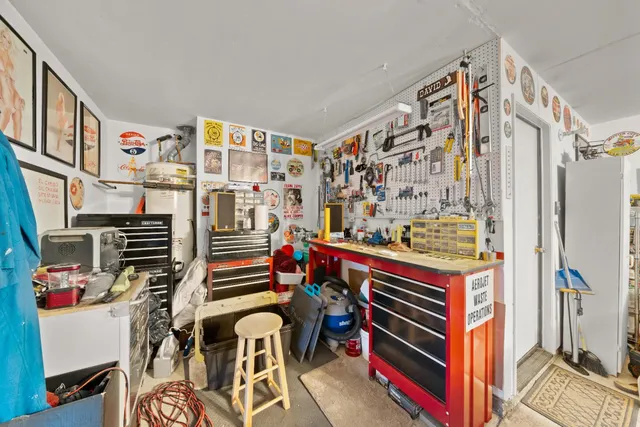 a view of a workspace with furniture and a flat screen tv