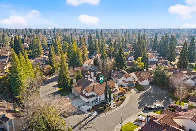 an aerial view of a house with garden space and street view