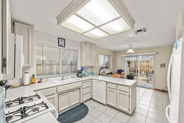a kitchen with a sink stove and white cabinets