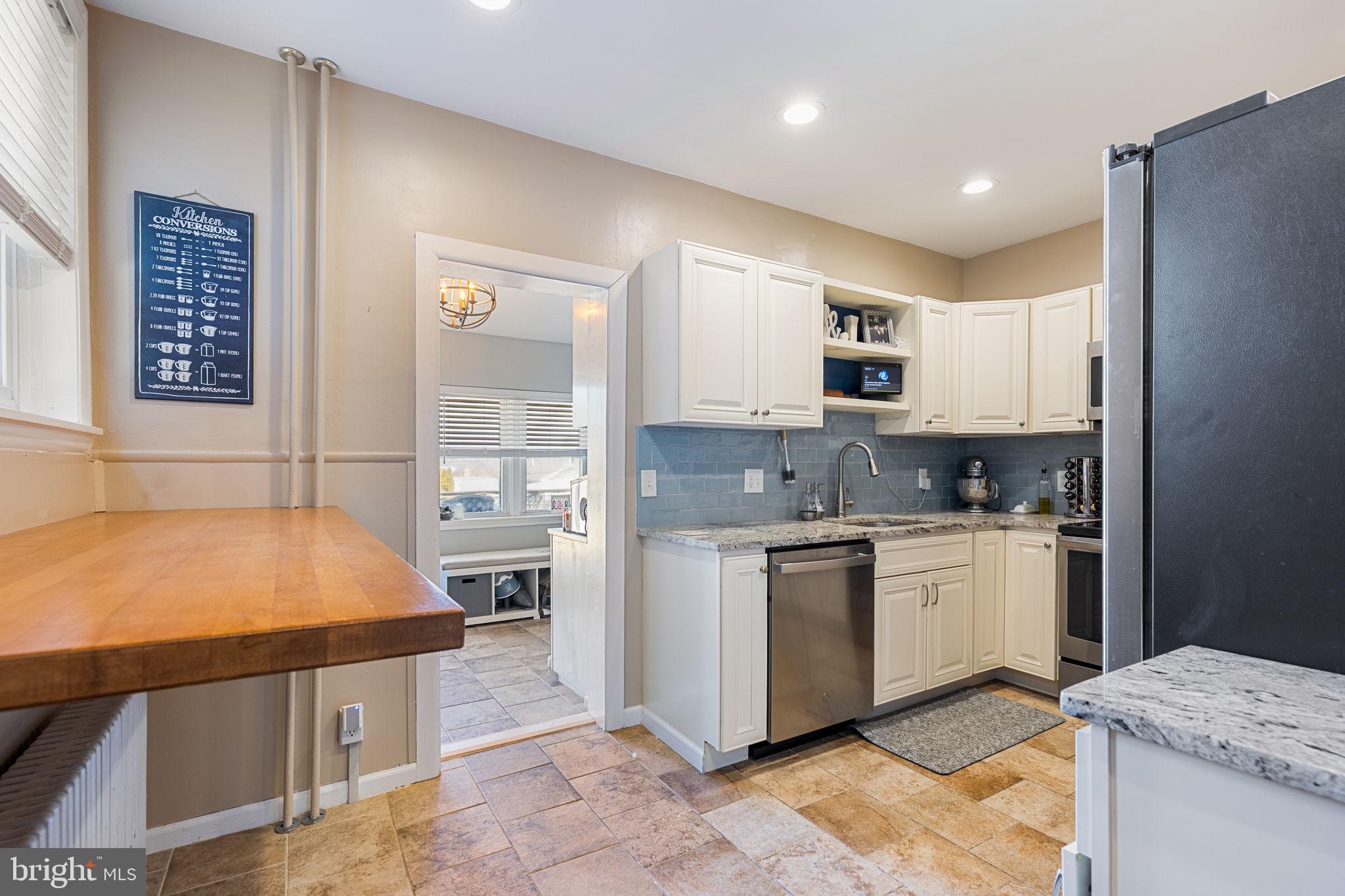 820 Maple Street Conshohocken, PA 19428 - Photo 16 of 43 a kitchen with stainless steel appliances granite countertop a stove a sink and a refrigerator