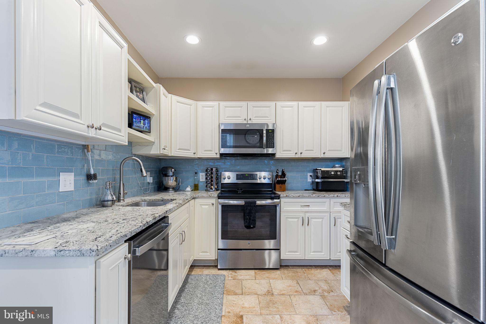 820 Maple Street Conshohocken, PA 19428 - Photo 17 of 43 a kitchen with stainless steel appliances granite countertop a refrigerator sink and microwave