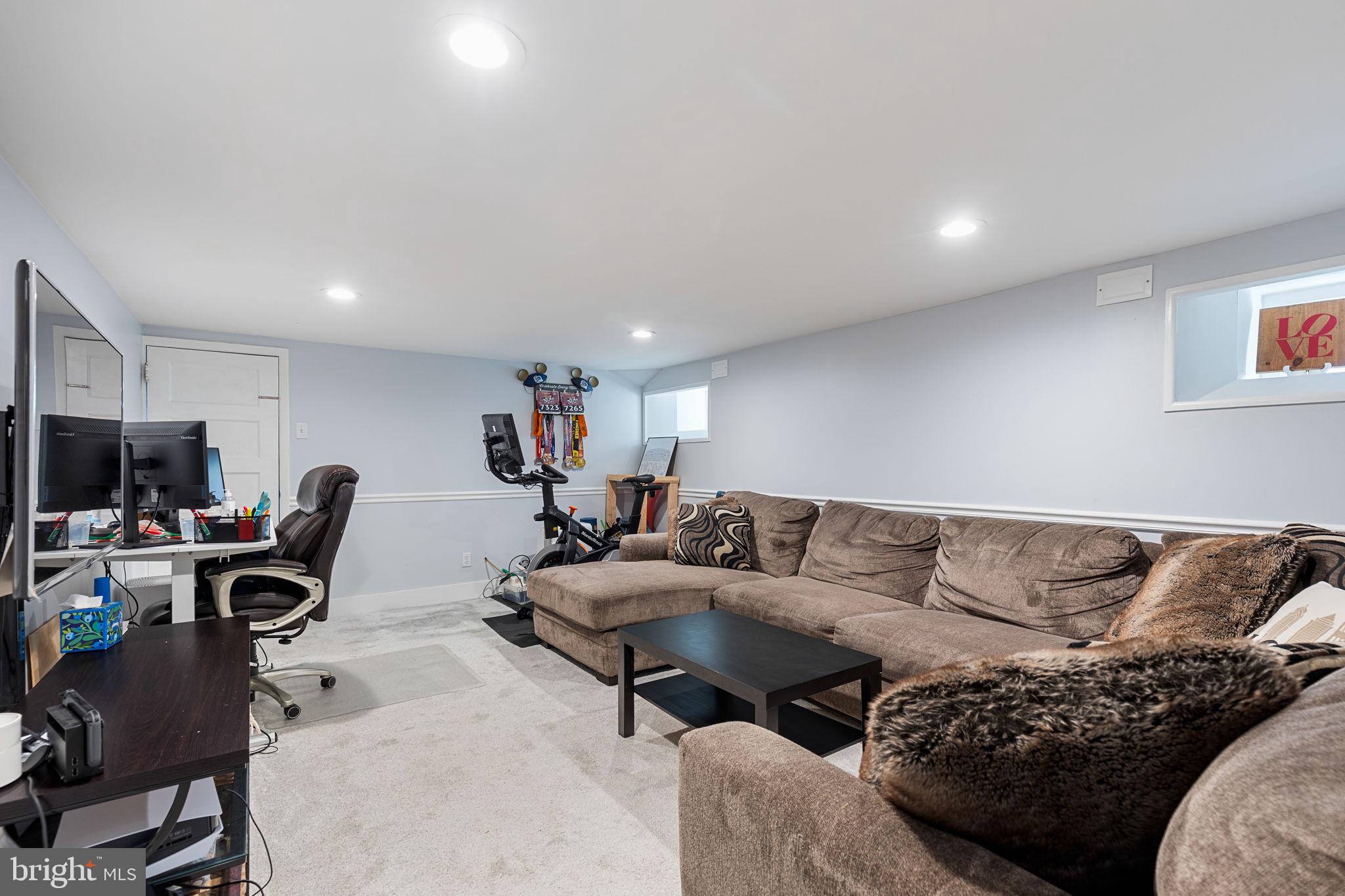 820 Maple Street Conshohocken, PA 19428 - Photo 39 of 43 a living room with furniture a flat screen tv and a window