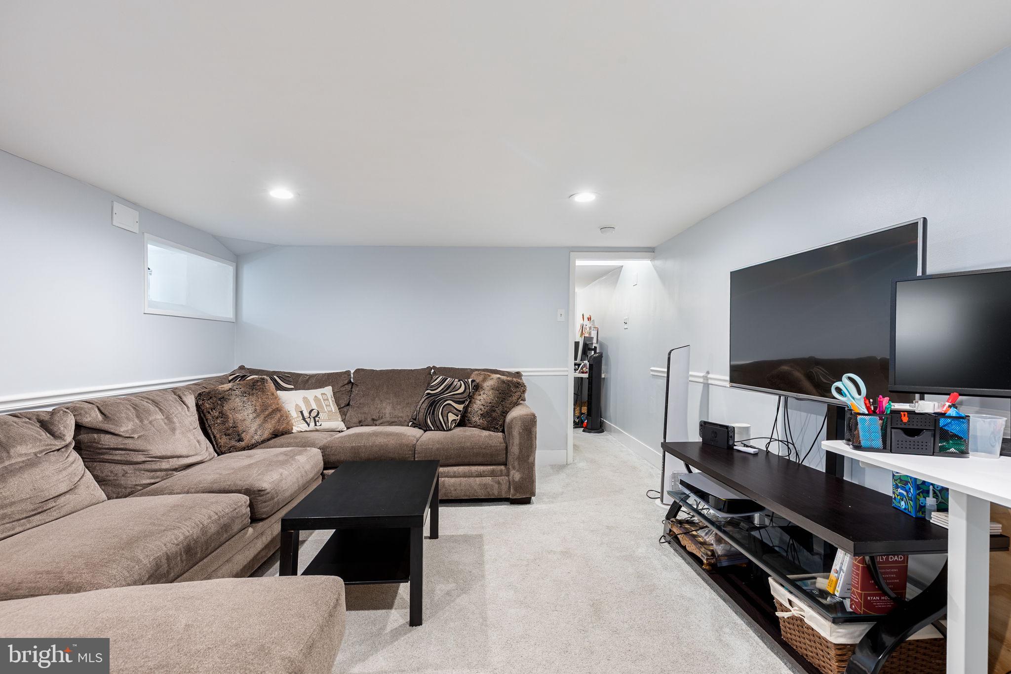 820 Maple Street Conshohocken, PA 19428 - Photo 40 of 43 a living room with furniture and a flat screen tv